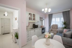 a kitchen and living room with a table and a couch at Park Apartment in Niksic in Nikšić +3 photos