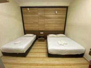 Postel nebo postele na pokoji v ubytování Haji Saudi Hotel