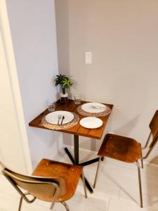 a dining room table with two plates and two chairs at AOCA KAMINOGE 402 in Tokyo