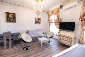 a living room with a couch and a desk at Studio du Maire Maison de L'Église du Couvent in Narbonne