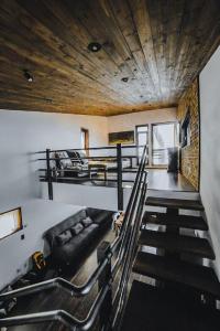 a room with a staircase with a couch and a room with at ESCAPE in Petroşani