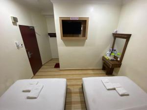 Postel nebo postele na pokoji v ubytování Haji Saudi Hotel