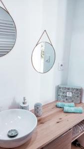 uma casa de banho com um lavatório e um espelho num balcão de madeira em L'Elégant - Idéal Couple - Parking Gratuit em Pau