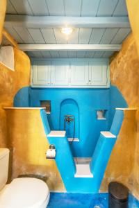 bagno con servizi igienici e parete blu di Villa Ghisi ad Arnádhos