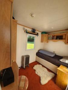 a small room with a bed and a window at 'Runway View' at Shobdon Airfield, Herefordshire in Shobdon