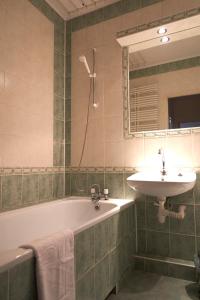 a bathroom with a sink and a bath tub and a sink at Apartament Sybiraków in Białystok +41 photos