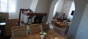 a living room with a fireplace and a couch at Montplaisir in Montendre