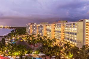 a view of a resort at night with the ocean at Sheraton Buganvilias Resort & Convention Center in Puerto Vallarta