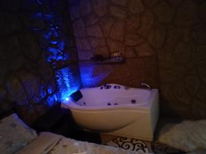 a bathroom with a bath tub and a sink at To Konaki in Synikia Mesi Trikalon +17 photos