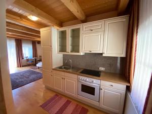a kitchen with white cabinets and a sink at Gestehof Hetzenberg in Haag