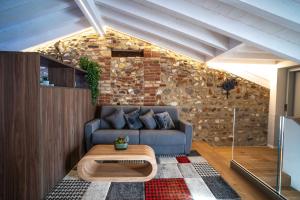 a living room with a couch and a table at Loft Roby in Peschiera del Garda