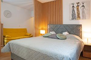 a bedroom with a bed with two pillows on it at TeonaLux Kraljevi Cardaci 5a/22 in Kopaonik +19 photos