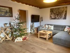 a living room with a christmas tree and a couch at Almhaus-Klippitz in Klippitztorl