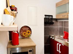 a kitchen with a counter with a microwave and a stove at Ferienwohnung Familie Leinweber in Waren