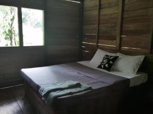 a bedroom with a bed with a blanket on it at Trekkers' Hut Knuckles in Kaduwela