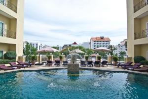 a pool with a fountain in the middle of a building at LK Residence in Pattaya Central