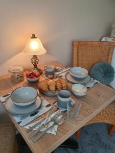 a table with plates and bowls of food on it at Chynoweth Lodge in Newquay