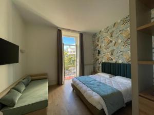 Postel nebo postele na pokoji v ubytování Lolli Palace Hotel