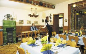 Ein Mann, der an einem Tisch in einem Restaurant sitzt. in der Unterkunft Gasthaus Merkel Hotel in Bad Berneck im Fichtelgebirge