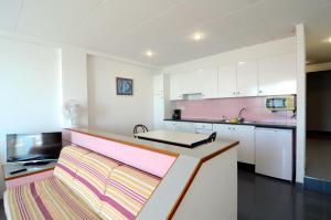 a kitchen with white cabinets and a counter top at Nautic BX-3 in L'Estartit