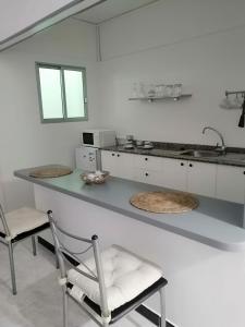 a kitchen with a sink and a counter top at Pensión Playa in Los Cristianos