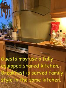 a kitchen with a sink and a counter top with a counter at Rongahuset BnB in Evanger