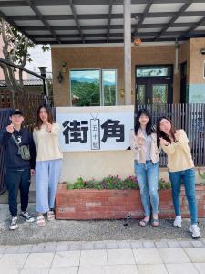 a group of people standing in front of a building at Corner No50 Hostel in Taitung City