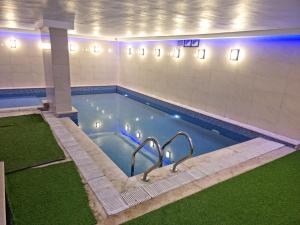 a swimming pool in a building with a pool at City Tower Hotel in Aqaba