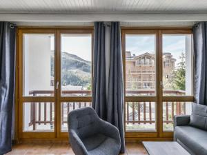 a living room with a couch and a chair at Appartement Courchevel 1650, 2 pièces, 5 personnes - FR-1-514-65 in Courchevel