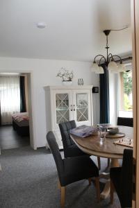 a dining room and living room with a table and chairs at Ferienwohnung Jesse in Braunlage