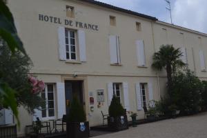 a white building with the hotel de palace on it at Hôtel de France in Libourne