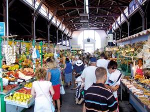 a group of people in a market with fruits and vegetables at Appartement SOULAC SUR MER À 500 m de la plage N 3 in Soulac-sur-Mer