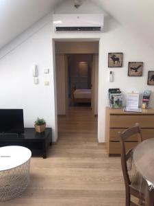 a living room with a table and a dining room at Logement cosy à Durbuy in Durbuy