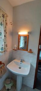 a bathroom with a white sink and a mirror at The Retreat in Pett
