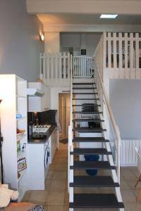 a kitchen with a spiral staircase in a room at Appartement SOULAC SUR MER À 500 m de la plage N 7 in Soulac-sur-Mer