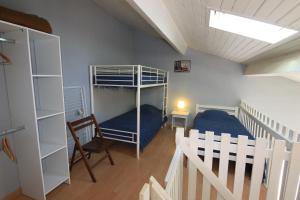 a room with two bunk beds and a chair at Appartement SOULAC SUR MER À 500 m de la plage N 7 in Soulac-sur-Mer