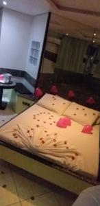 a bed with some red roses on it at Motel dos Arcos (Adult Only) in Porto Alegre