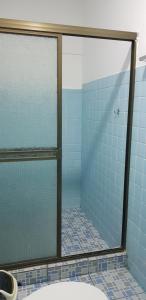 a bathroom with a glass shower with blue tiles at Tapihouse San Juan Del Sur in San Juan del Sur
