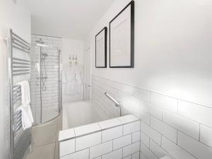 a white bathroom with a tub and a shower at 3 Chestnut Terrace, Long Melford in Long Melford