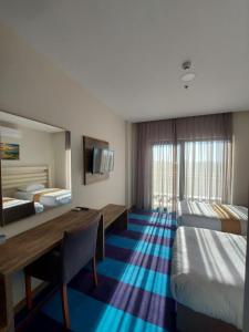 a hotel room with two beds and a desk at İpsala Park Hotel in İpsala