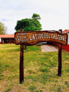 a sign in the grass in front of a building at Estancia San Carlos in Luan Toro