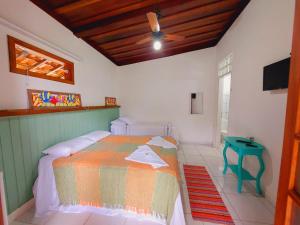 A bed or beds in a room at Pousada Capim Melado