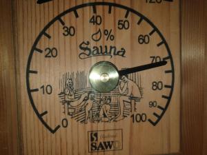 a clock on a wooden door with a picture on it at Henye holiday homes in Balatonhenye