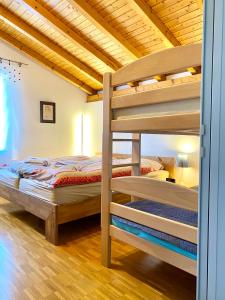 a bedroom with two bunk beds in a room at Comano Lugano Ticino - B&B Walterina in Comano
