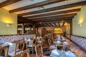 a restaurant with wooden tables and chairs in a room at Hotel LIVVO Volcán Lanzarote in Playa Blanca