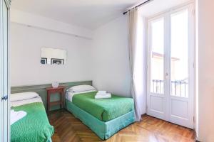 Un pat sau paturi într-o cameră la San Giacomo Central Apartment