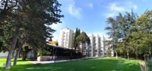 a park in front of a building with trees at Green Hill Hotel in Stara Zagora