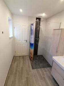 a bathroom with a shower and a tile floor at Oklahoma Home in Ockholm +18 photos