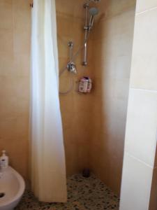bagno con doccia, lavandino e servizi igienici di Casetta Rosina a Scopello