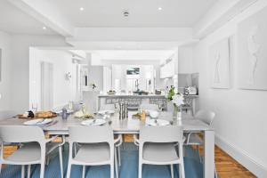 a kitchen and dining room with a table and chairs at HOE PARK HOUSE, Historic Gem, Accommodates 10, Parking, Pets Welcome, Prime Location Near Eateries, Bars & Stunning Coastal Views in Plymouth